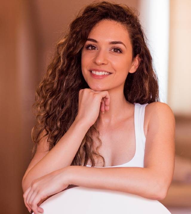 Portrait of a smiling young woman at home